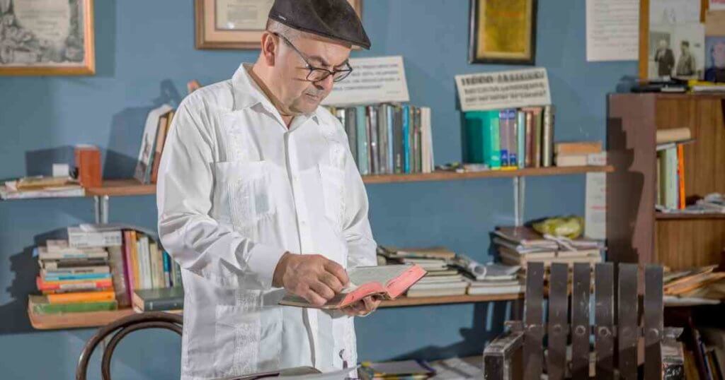 man checking his books for decluttering